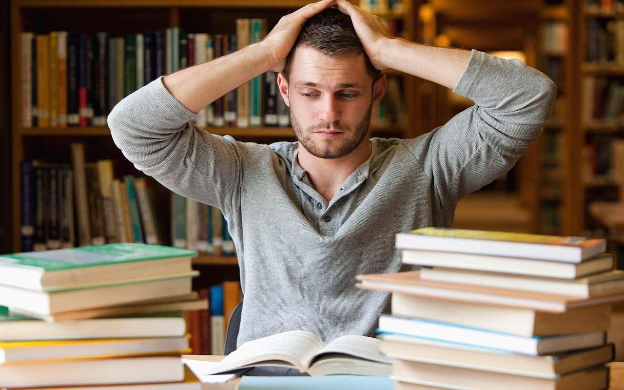 Confused student staring at complex physics equation on digital screen, unsure where to start
